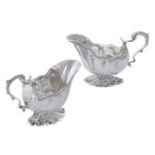 A pair of late Victorian cast silver shaped oval sauce boats by William Hutton & Sons Ltd