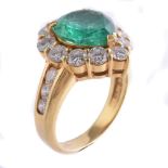 An emerald and diamond ring