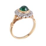 An emerald and diamond ring