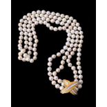 A four row cultured pearl necklace to a gold coloured diamond set clasp