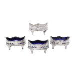 A set of four George III silver oval salt cellars by Henry Chawner