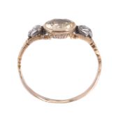 A yellow stone and diamond ring