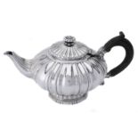 A George IV silver shaped circular tea pot by Robert Hennell II
