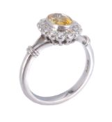 A platinum, yellow sapphire and diamond ring