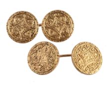 A pair of gold coloured cufflinks