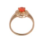 An 18 carat gold fire opal and diamond ring