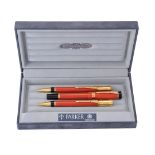 Parker, Duofold, an orange ball point pen, roller ball pen and propelling pencil