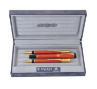 Parker, Duofold, an orange ball point pen, roller ball pen and propelling pencil