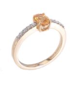 A yellow sapphire and diamond ring