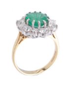 An emerald and diamond cluster ring