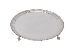 A silver shaped circular salver by Harrods Stores Ltd