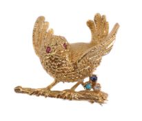 A 1970s 18 carat gold and gem set bird brooch