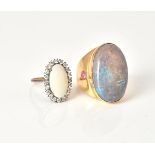 An oval shape opal and white simulant stone cluster ring
