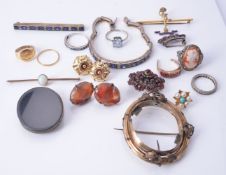 A collection of jewellery including an opal bar brooch; a blue and white sapphire bracelet and panel