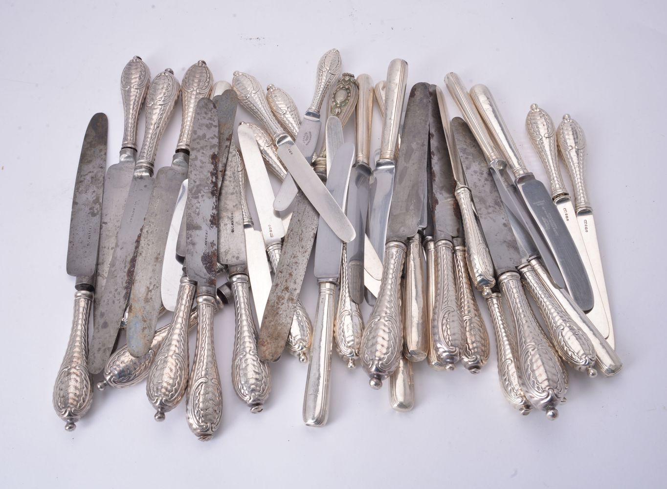 A set of twelve George III silver handled quilted variant pattern table knives