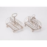 Two similar silver six division toast racks