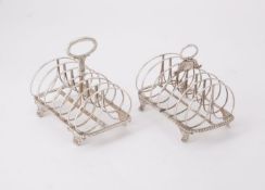 Two similar silver six division toast racks