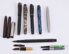 A collection of fountain pens and spare parts
