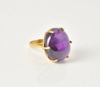 An oval cabochon amethyst ring