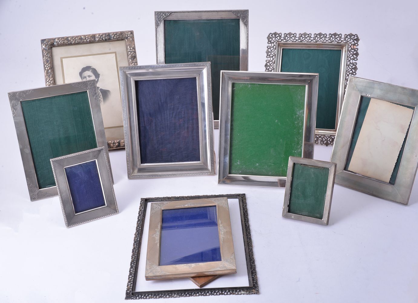 Twelve silver or silver coloured rectangular or shaped rectangular photograph frames