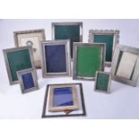 Twelve silver or silver coloured rectangular or shaped rectangular photograph frames
