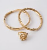 A pair of gold coloured hinged bangles