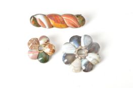 Three Scottish hardstone brooches:- a silver-coloured and agate brooch of shaped circular form set w