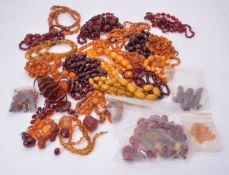 A large group of amber coloured and amber bead necklaces