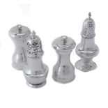 Two silver pepper casters and two pepper mills