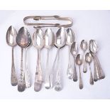 A collection of silver spoons and sugar tongs