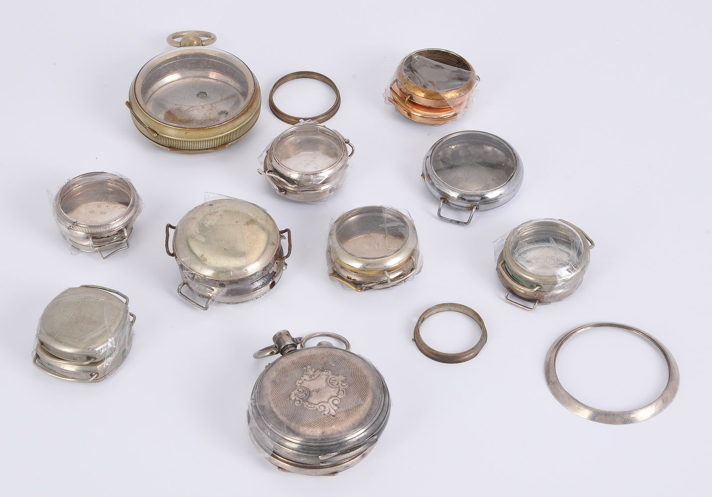 A collection of pocket watch and wrist watch cases