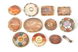 A collection of twelve hardstone brooches