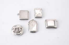 A silver novelty Man-in-the-Moon vesta case and others