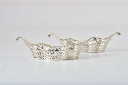 A pair of Edwardian silver shaped navette sweet baskets by Sibray, Hall & Co. Ltd