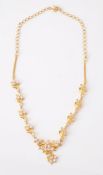 A gold coloured white stone necklace