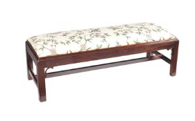 A mahogany framed low long stool in the George III style
