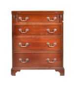 A modern reproduction mahogany bachelor’s chest