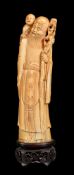 ϒ A Chinese ivory standing figure of Shoulao with attendant