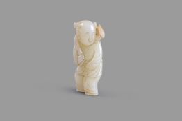 A white and russet jade carving of a boy