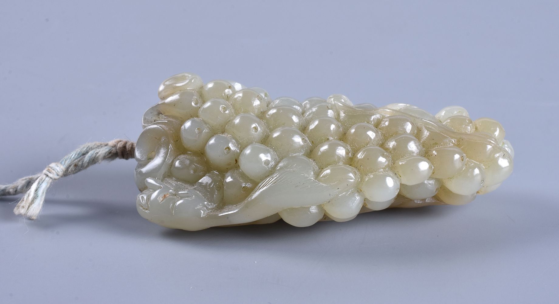 A Chinese celadon and russet jade 'Grape and Squirrel' carving - Image 2 of 4