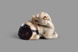 A Chinese white and dark brown jade figure of a mythical beast
