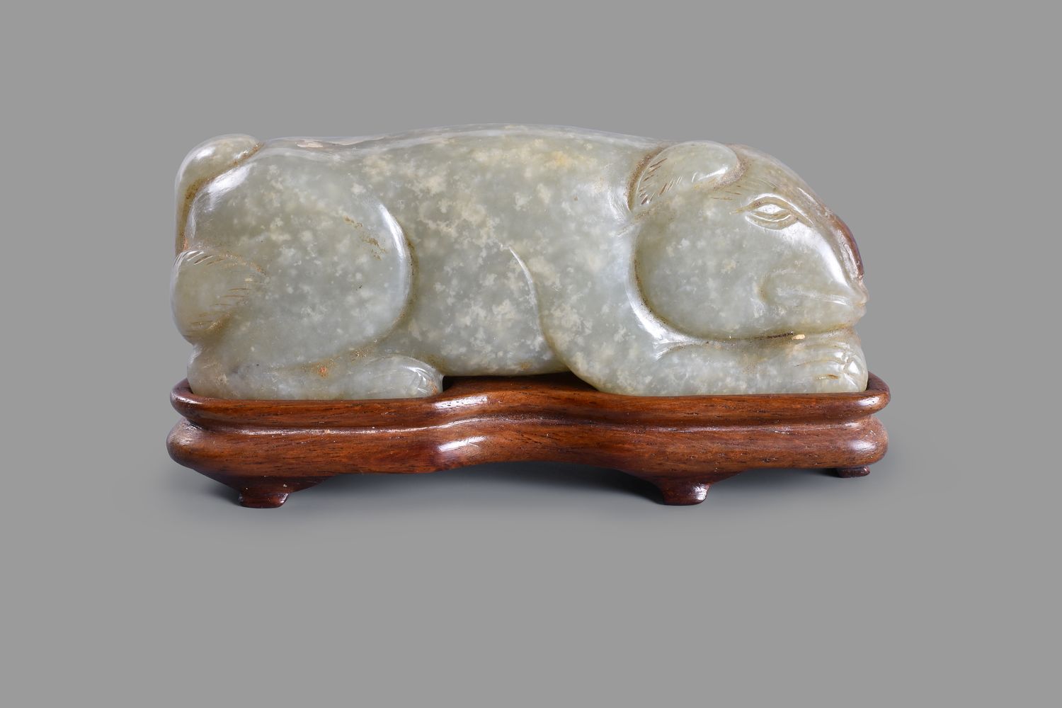 A Chinese mottled celadon jade model of a dog