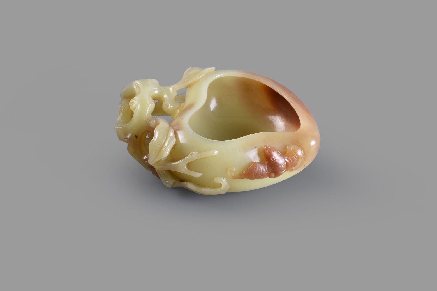 A yellow jade and russet peach-form water pot