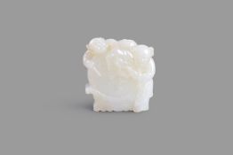 A white jade carving of two boys and a drum