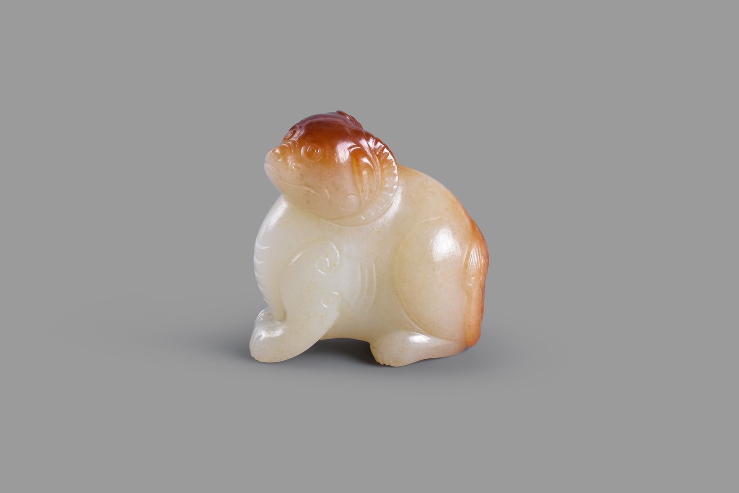 A white and russet jade carving of a mythical beast