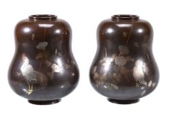 A Pair of Japanese Vases each of squat double-gourd form resting on a short splayed foot and with a