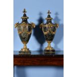 A pair of French green serpentine marble and gilt metal mounted urns in Louis XVI style