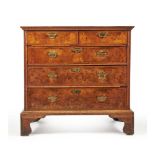 A Queen Anne burr walnut, figured walnut and feather banded chest of drawers, circa 1710