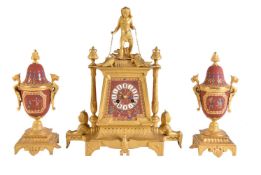 A French burnt-umber-tinted biscuit porcelain and gilt-metal-mounted clock garniture in the Egyptian