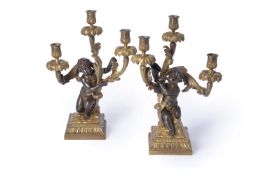 A pair of fine gilt and patinated bronze three light figural candelabra in late Louis XV taste, by H